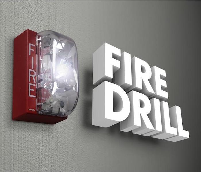 red fire alarm hanging on gray concrete wall