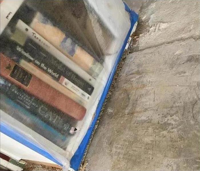 Book shelf covered with plastic. 