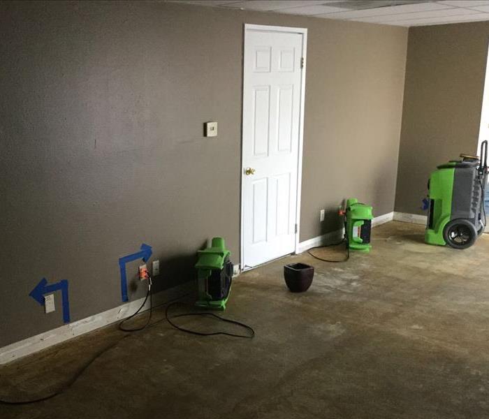 Air mover and dehumidifier drying a wall