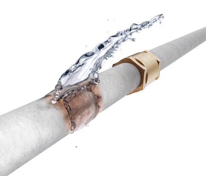 water leaking out of a gray pipe showing signs of erosion
