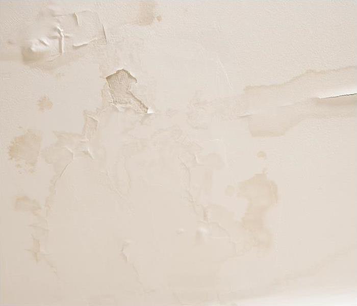 tan wall with water damage spots showing through