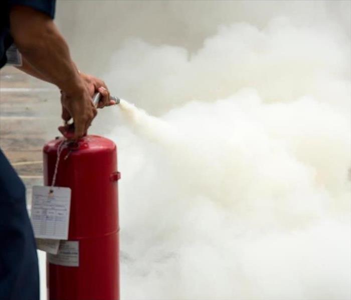 A man is putting out a fire