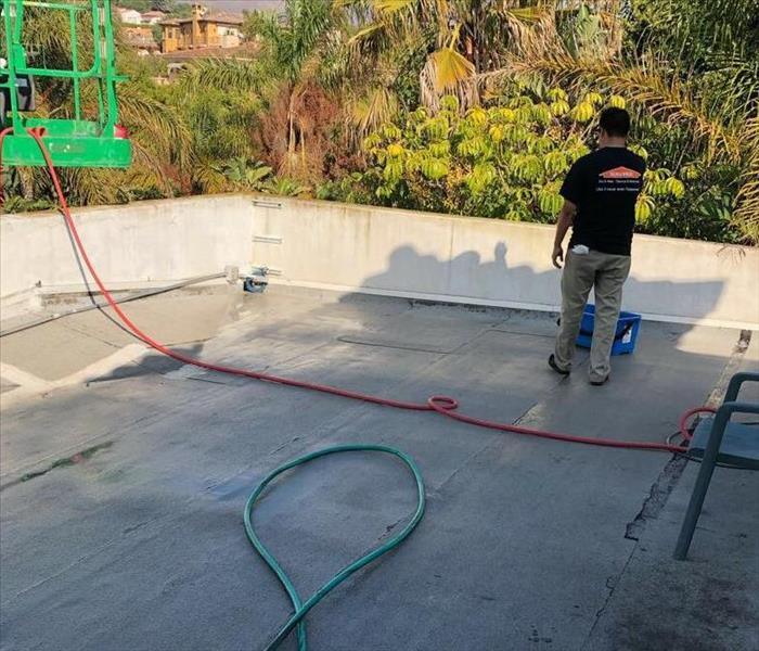 Roof of home in Malibu being cleaned by SERVPRO technician 